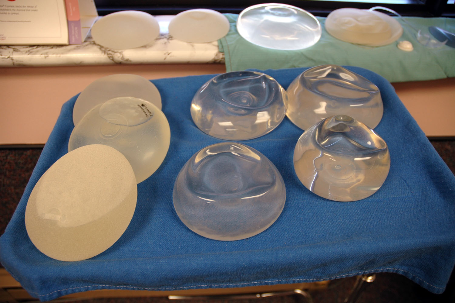 various breast implants as samples on a tray in  a doctors office